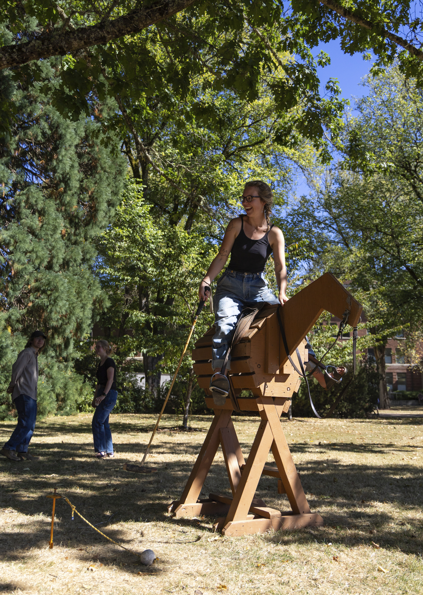 Student riding wooden horse during Beaver Community Fair