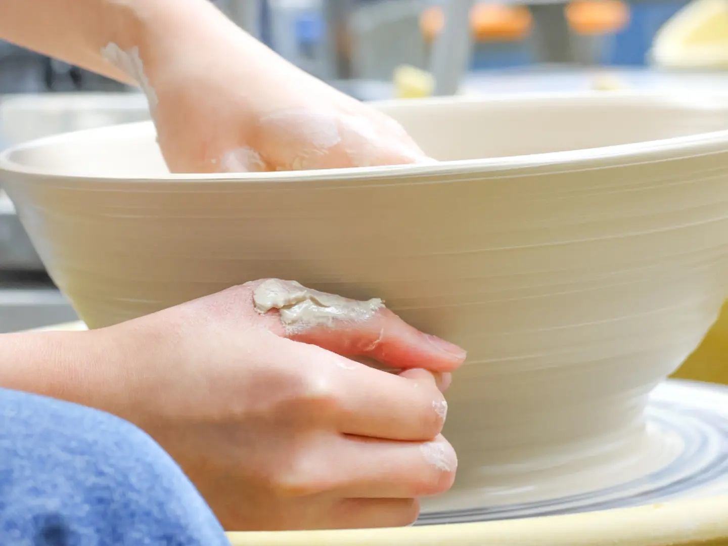 Craft Center member using pottery wheel 